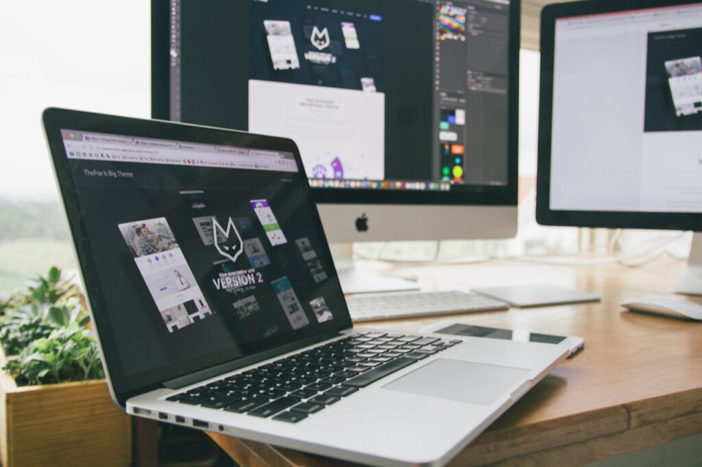 Macbook Pro Displaying Website Version 2 on Table